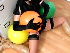 Secretary in the office in stockings playing with balloons