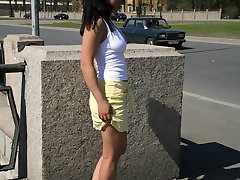 Brunette flashes ass and tits on a sun-lit street