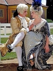 Costumed couple screw in the garden