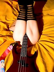 Wild tattooed Goth girl with her guitar