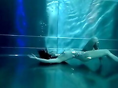 Bond Girl, underwater stunts, bore girl, high high-heeled shoes glamor and underwater swimming retro style 