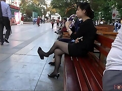 Chinese Office Chick having a break and dangling her heels