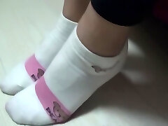 Asian footjob with socks on pants