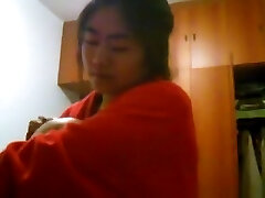 Asian girl with gigantic boobs changes clothes in her bedroom