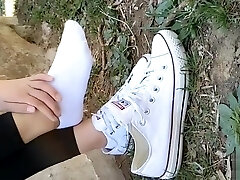 Chinese girl sprains foot in white ankle socks and ebony stretch pants