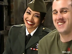 Asian lady in military uniform spanks a guy and sits on his face
