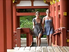 Lesbian couple kissing and flashing at a Asian temple