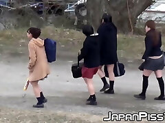 Four Japanese schoolgirls dummy around outside before peeing