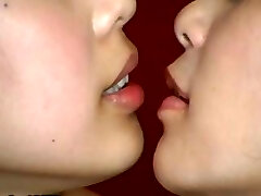 Two Japanese dolls are doing some weird kissing with a mouth butt-plug