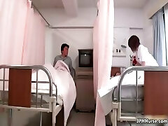 Handsome Japanese nurse gives a patient some partThree