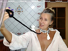 Red-hot hostess Lukerya in the kitchen in a dressing gown.