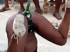 Jamaican girl pounding with a bear bottle