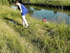 Nudist beach. Public nudity. Sexy MILF without panties and bra sunbathes naked is not bashful about fisherman. Naked in public. Cougar