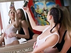2 girl poke front of mirror