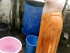Anita yadav bathing outside with red-hot