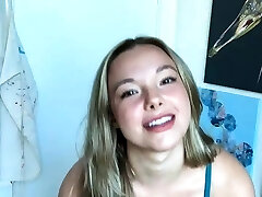 Warm amateur teen in a personal show masturbating with a dildo