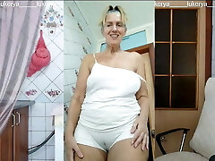 Lukerya in the kitchen in wet white panties, bottom sight