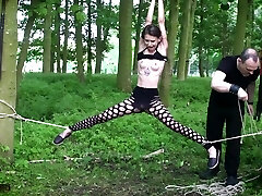 Submissive teen roped up in the woods
