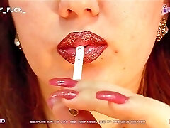 Shiny painted lips deep throating a cigarette