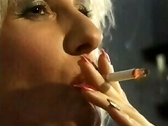 Smoking fetish whore in red leather 'n lipstick dped & takes dual facial