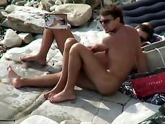 Breasty tramp sucking cock on a beach
