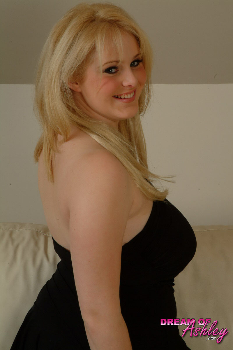 Busty teen pulls down her black dress to release her big boobs