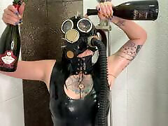 Dominatrix Nika in a gas mask pours wine over her groul sex body. baby attacker fetish