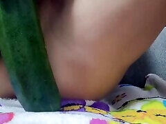 Kinky whore uses zucchini and cucumber to stretch her both holes at once