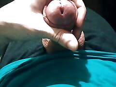 Guy in blue t-shirt jerking off his cock sitting in chair