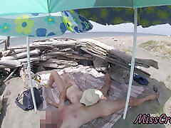 On a nudist beach in Tenerife, the stepdaughter jerks off her stepfather&039;s cock without shame