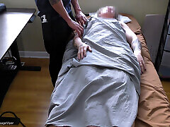 Fit Blonde Massage Client Showing Off to Masseur