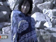 Lovely Little Oriental Betty Removing Clothes on the Beach