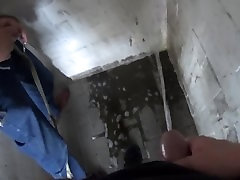 two friends pissing together in the parking garage two friends pissing together in the parking garage