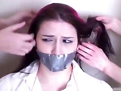 School girl tied and tape gagged on the chair by two school girls School girl tied and tape gagged on the chair by two school girls