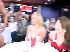 Handsome stripper entertains a huge crowd of horny girls dancing saliva on suck in a club