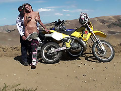 Biker girl blows and fucks her partner in the desert