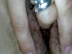 Mature woman fingering her hairy vagina