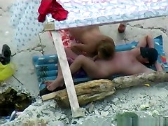 Voyeur tapes a nudist couple having oral baby clean kiss at the beach