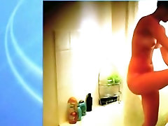 Voyeur captures a hot nerdy girl with glasses naked in the shower