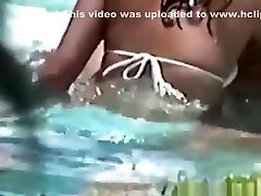 Voyeur tapes a latin couple having ass hot in the pool