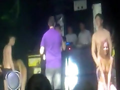 2 russian couple have a beg gayes game on stage in a disco