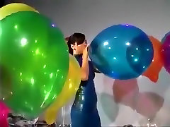 Sexy Girl In Latex care of boners Blows to Pop Some Big Balloons