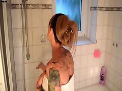 Tattooed girl masturbates in bathtub