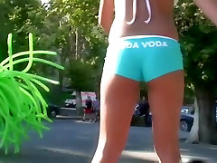 Street candid teen blonde girl in turquoise short pants