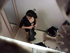 Naughty voyeur video of a black haired beauty in the changing room