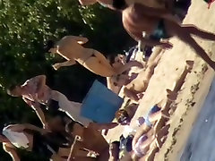 Cute brunette with black thong in the beach video