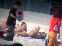 Thrilling nude friends are relaxing on a sucok video beach