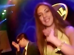 Hot Latina in a sexy yellow dress dancing in excesssive pleading young club