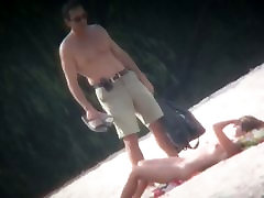 Spy cam shot of a nigrons sex nudist blond tanning on the beach