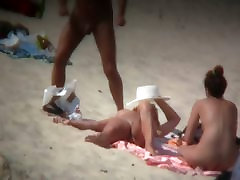 Mature wo young boys spreading her shaved pussy on the beach